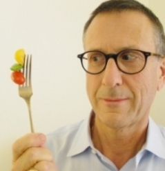 Stephen Bryant walker looks quizzically at a fork full of fruit