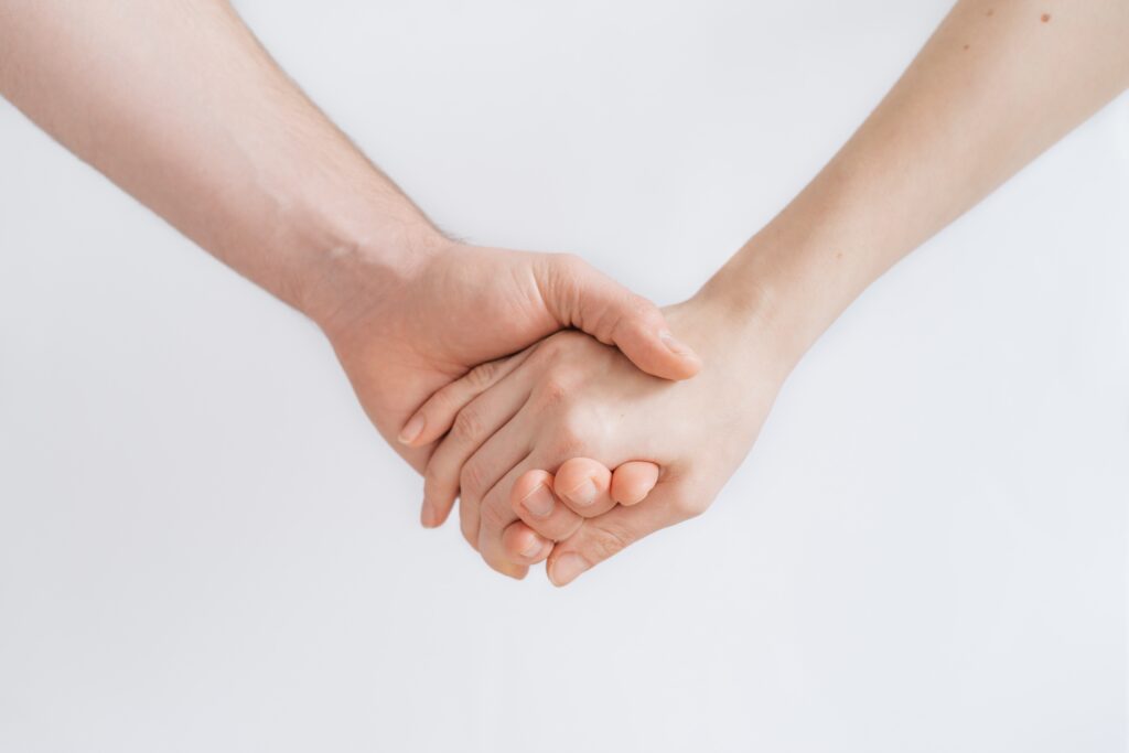 a photograph by roman kraft of two caucasian forearms with hands holding each other